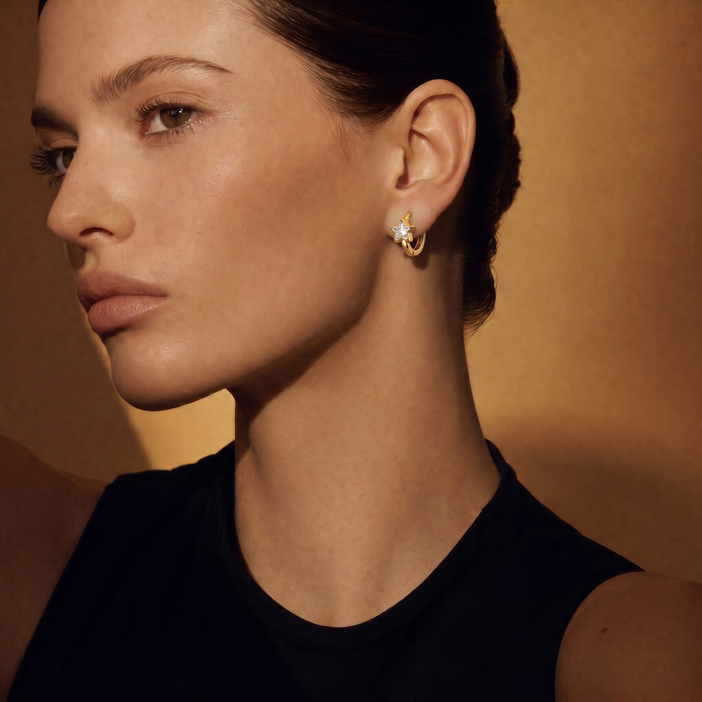 Star Huggie Hoops on model