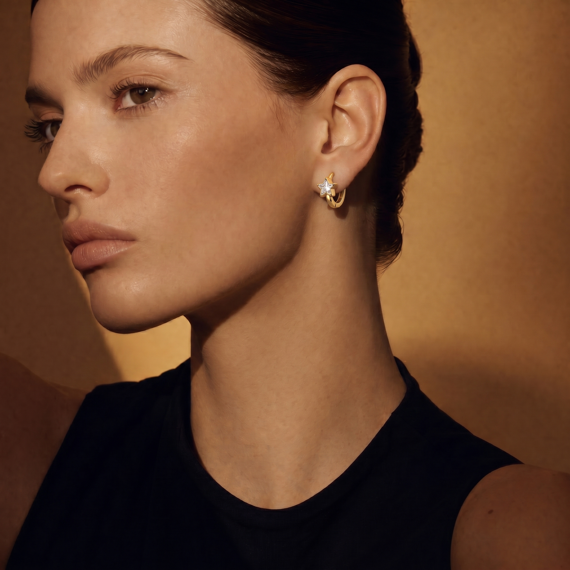 Star Huggie Hoops on model